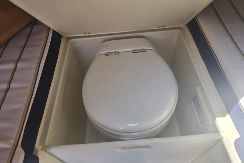 Slide: The Image of 2013 Chris-Craft Corsair 28 boat toilet in compact compartment. - 13