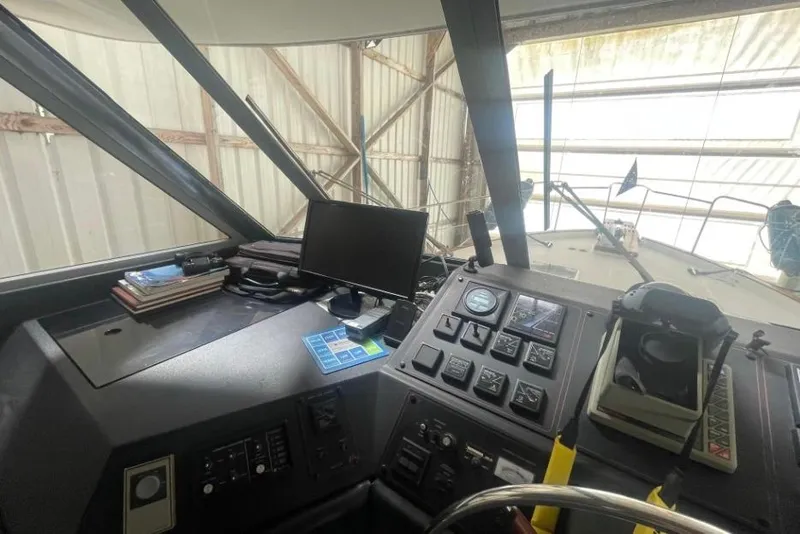 Slide: The Image of Interior view of 1988 Bayliner 4588 Pilothouse helm with navigation equipment. - 12