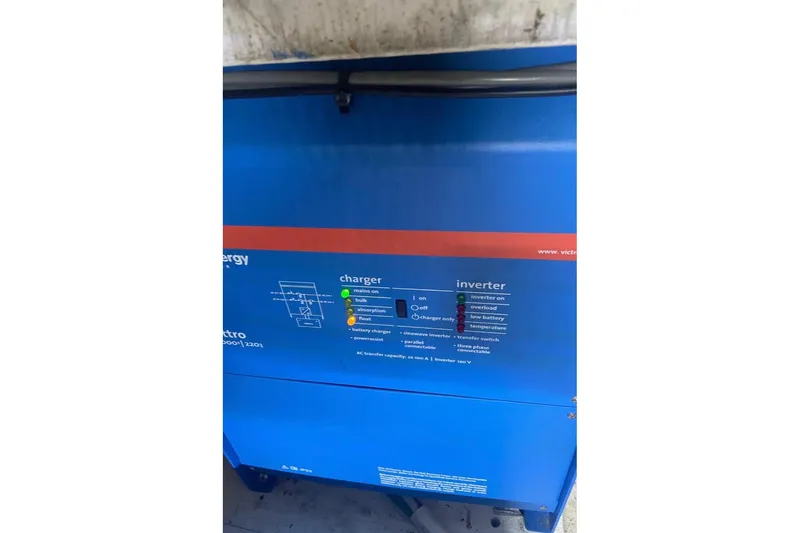 Slide: The Image of Blue Victron Energy inverter and charger unit on a 1988 Bayliner 4588 Pilothouse. - 32