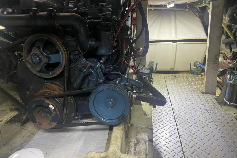 Slide: The Image of Engine room of a 1988 Bayliner 4588 Pilothouse with visible machinery and components. - 36