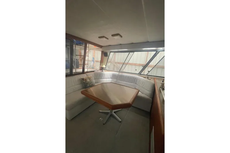 Slide: The Image of Interior of 1988 Bayliner 4588 Pilothouse with cozy seating and wooden table. - 6