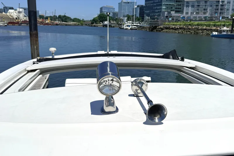 Slide: The Image of 2016 Sea Ray SLX 350 boat with chrome horns, docked in a marina. - 32