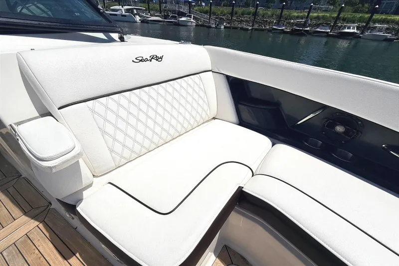 Slide: The Image of Luxurious seating on a 2016 Sea Ray SLX 350 boat, featuring elegant white upholstery. - 23