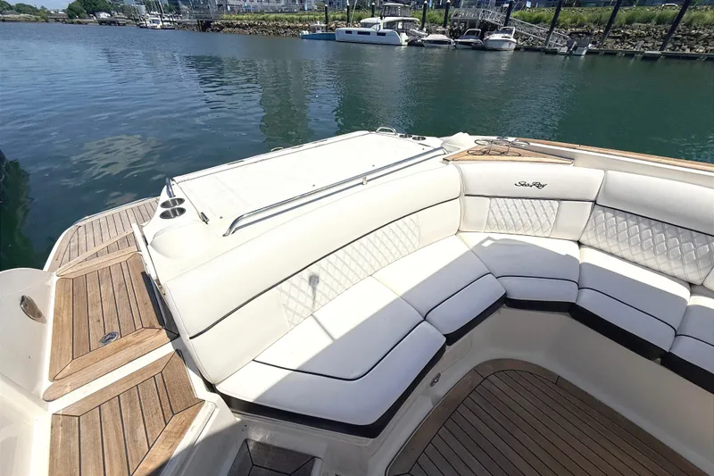 Slide: The Image of Luxurious 2016 Sea Ray SLX 350 boat with elegant white seating and teak flooring. - 11