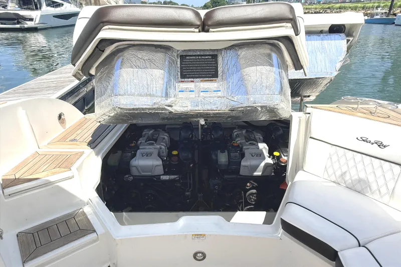 Slide: The Image of 2016 Sea Ray SLX 350 boat engine compartment with V8 engines at a marina. - 33