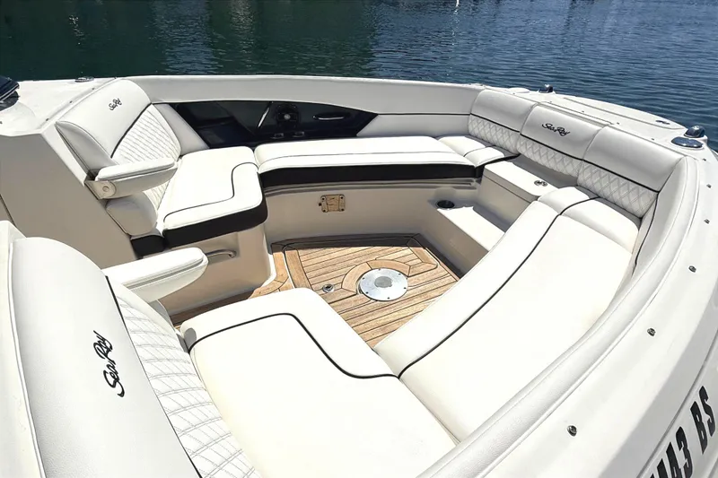Slide: The Image of Luxurious seating area on a 2016 Sea Ray SLX 350 boat, featuring elegant white upholstery. - 22