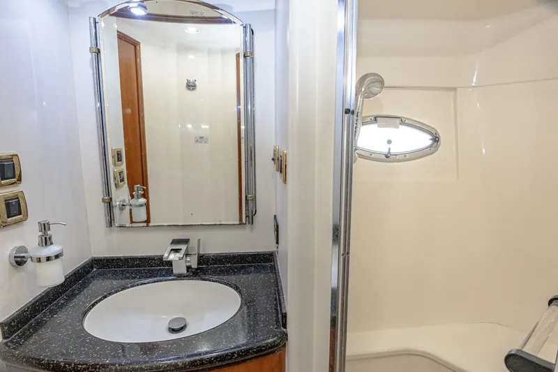 Slide: The Image of The image shows a sleek bathroom with a sink, mirror, and shower. - 28