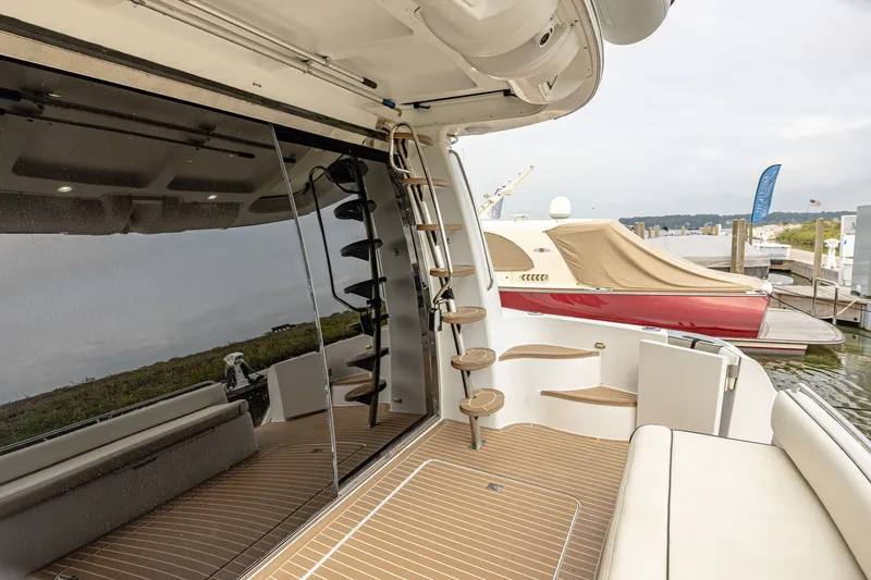Slide: The Image of The 2002 Carver 530 Voyager Pilothouse features a sleek deck with wood-like flooring and a staircase. - 6