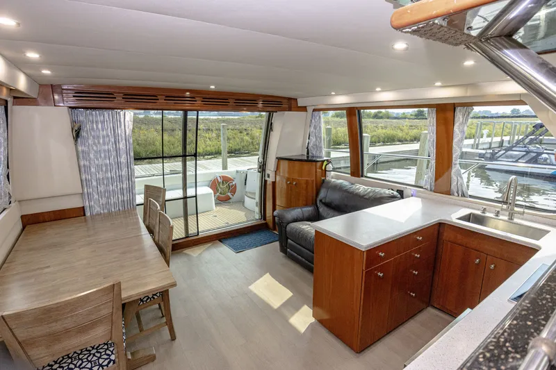 Slide: The Image of Interior of the 2002 Carver 530 Voyager Pilothouse featuring a dining area and kitchen. - 31