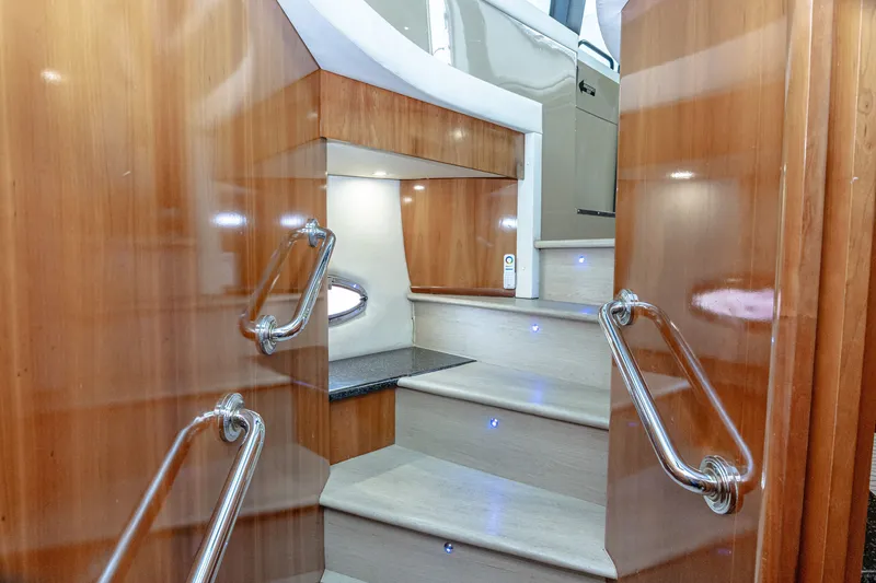 Slide: The Image of The interior stairs of the 2002 Carver 530 Voyager Pilothouse feature wood steps and stainless steel railings. - 29