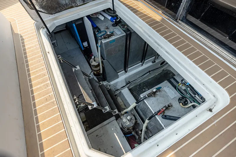 Slide: The Image of An open compartment on a boat reveals batteries and mechanical components. - 33