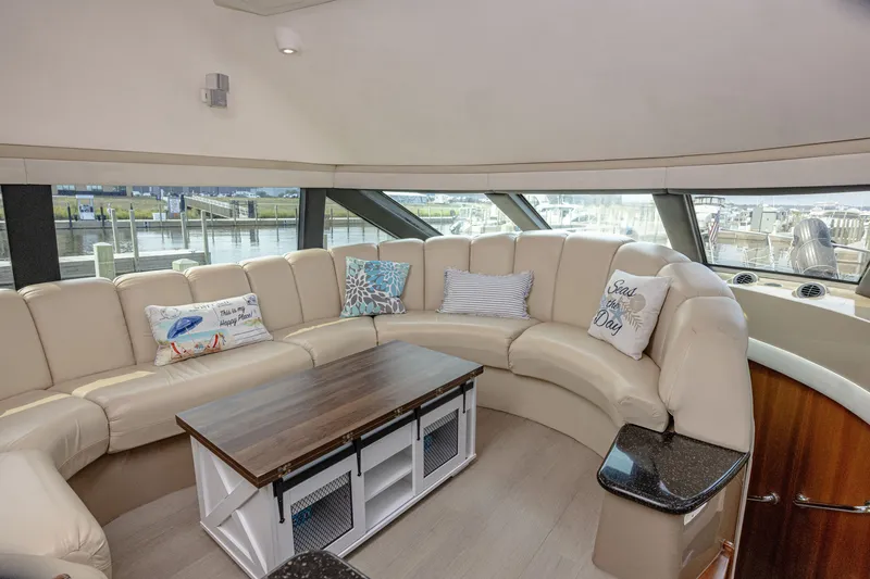 Slide: The Image of Interior of a 2002 Carver 530 Voyager Pilothouse with beige sofa and wooden table. - 9