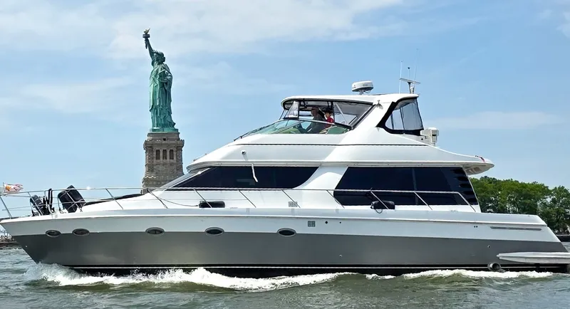 The Image of A 2002 Carver 530 Voyager Pilothouse yacht cruising near the Statue of Liberty. - 0