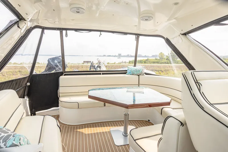 Slide: The Image of Interior of a 2002 Carver 530 Voyager Pilothouse with elegant seating area and table. - 11