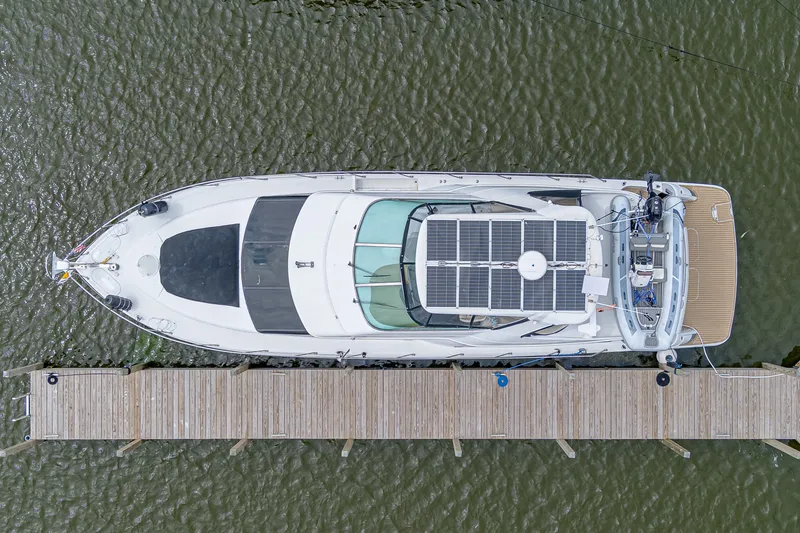Slide: The Image of Aerial view of a 2002 Carver 530 Voyager Pilothouse docked at a wooden pier. - 41