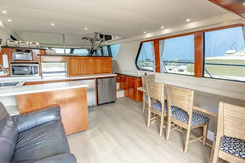 Slide: The Image of Interior of a 2002 Carver 530 Voyager Pilothouse with modern kitchen and dining area. - 7