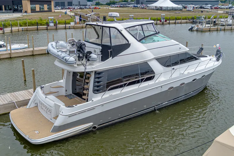 Slide: The Image of A luxurious motor yacht docked, featuring a spacious deck and sleek design. - 3