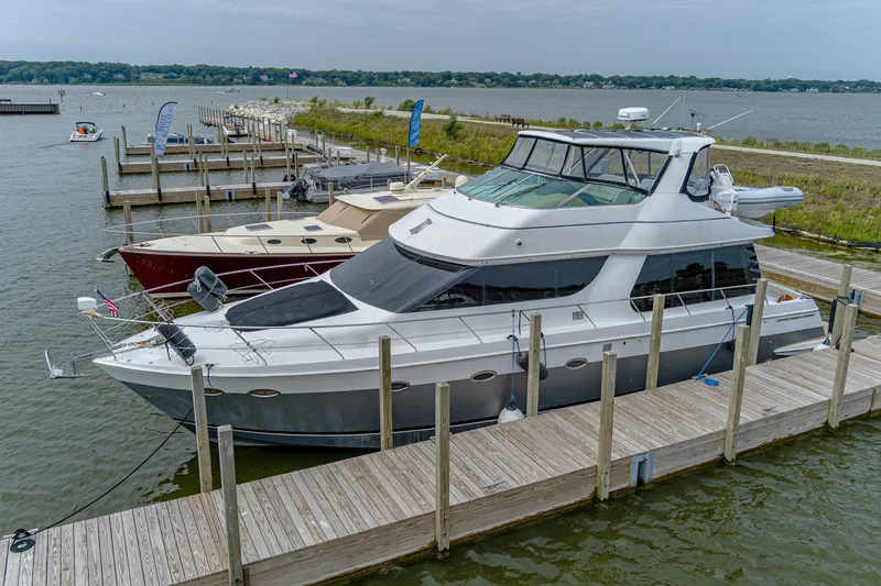 Slide: The Image of A 2002 Carver 530 Voyager Pilothouse docked. It features a sleek, modern design. - 2