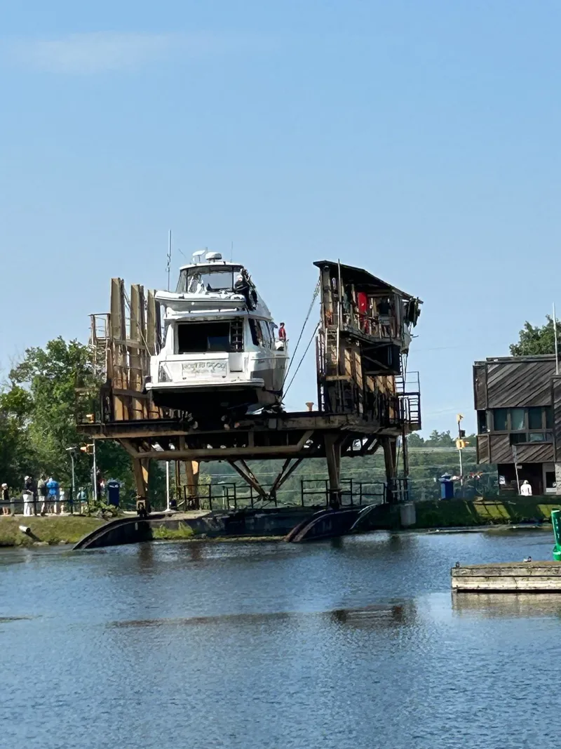 Slide: The Image of A 2002 Carver Voyager Pilothouse 530 is lifted on a platform over a river. - 6