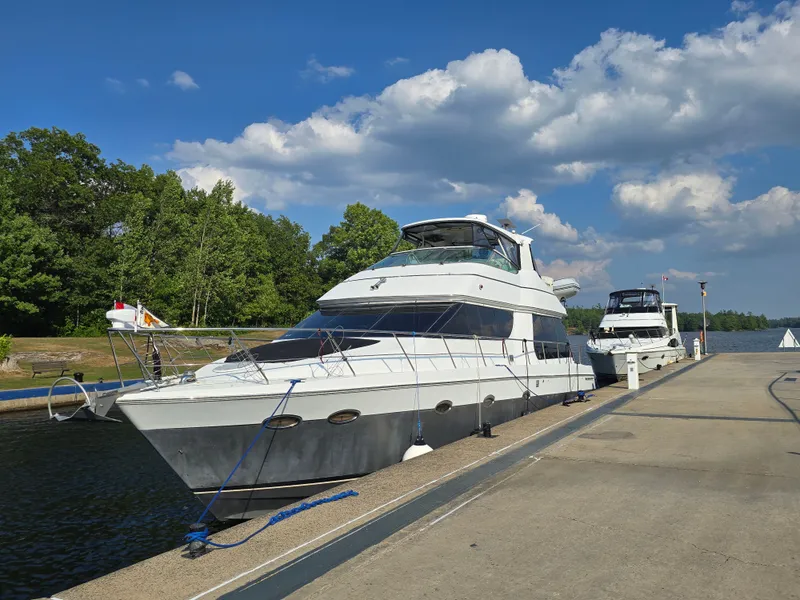 Slide: The Image of A 2002 Carver Voyager Pilothouse 530 docked on a sunny day. - 4