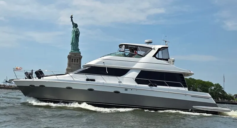 Slide: The Image of A 2002 Carver Voyager Pilothouse 530 cruising on the water near the Statue of Liberty. - 1
