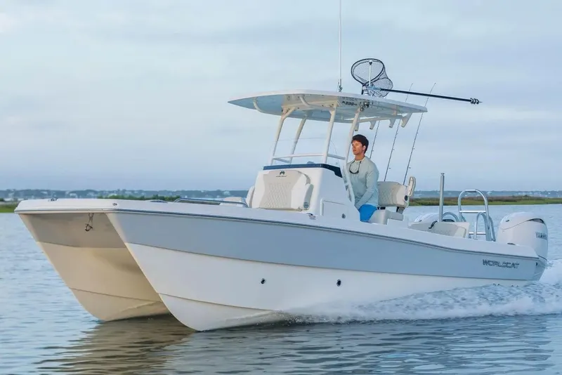 The Image of Manufacturer Provided Image: 2026 World Cat 235 HB boat cruising on calm waters with a person at the helm. - 0