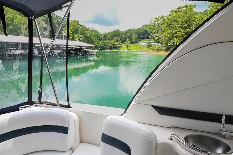 Slide: The Image of Interior view of 2008 Sea Ray 38 Sundancer overlooking serene lake and marina. - 14