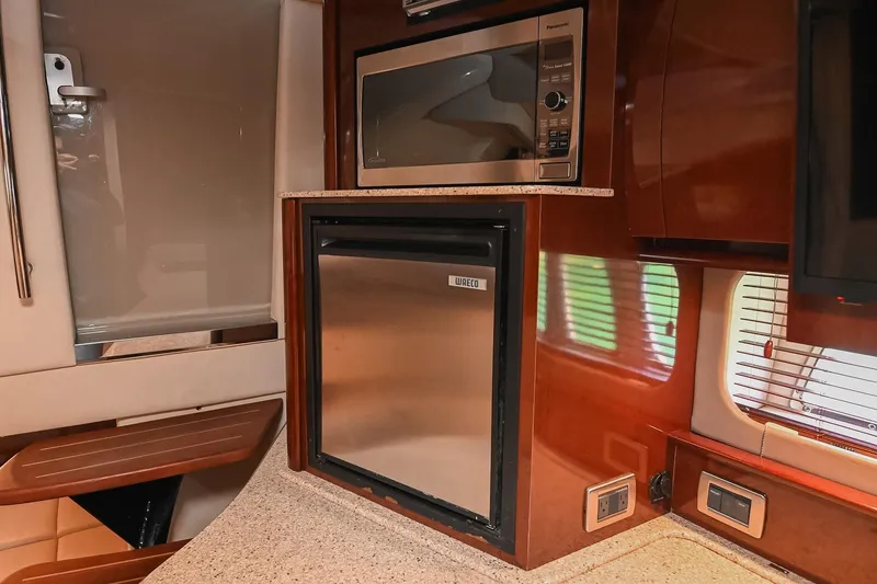 Slide: The Image of 2008 Sea Ray 38 Sundancer yacht interior with microwave and mini fridge. - 35