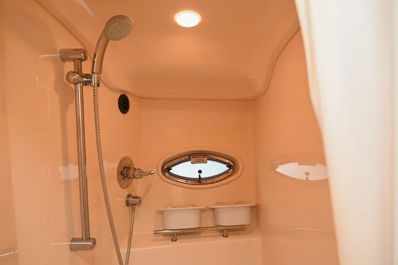 Slide: The Image of Shower area inside 2008 Sea Ray 38 Sundancer yacht, featuring modern fixtures and porthole window. - 54