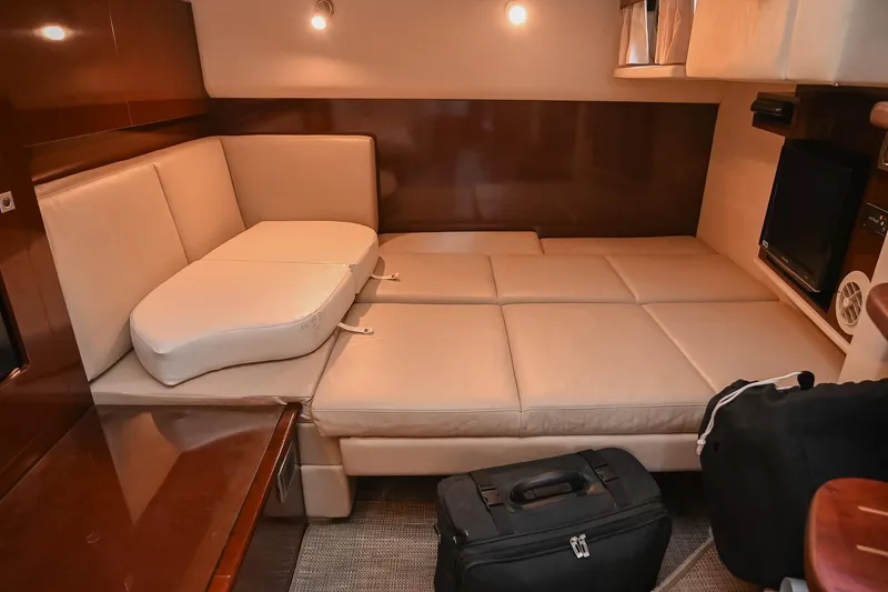 Slide: The Image of Luxurious interior of 2008 Sea Ray 38 Sundancer yacht with beige seating and luggage. - 39