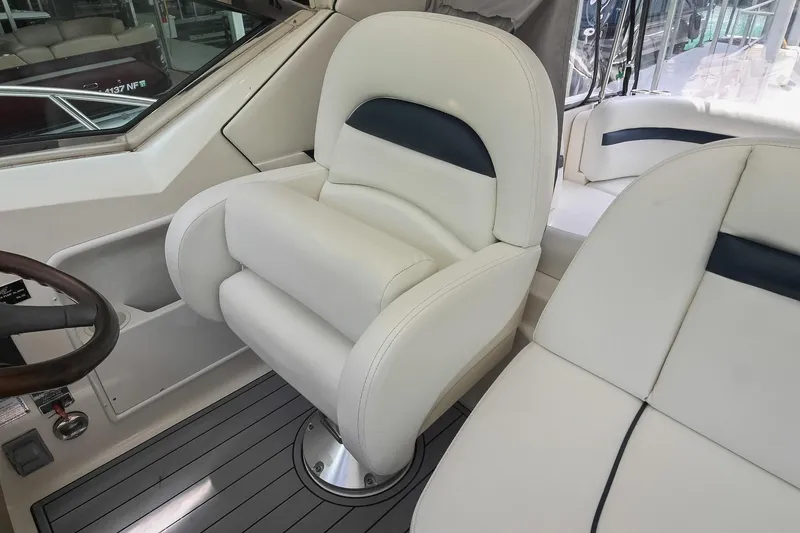 Slide: The Image of Captain's seat on 2008 Sea Ray 38 Sundancer yacht, featuring luxurious white upholstery. - 19