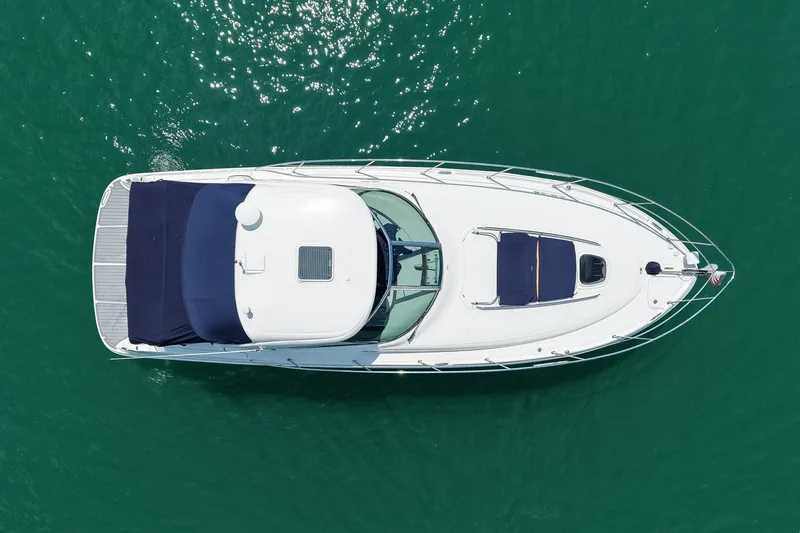 Slide: The Image of Aerial view of 2008 Sea Ray 38 Sundancer yacht on clear green water. - 68