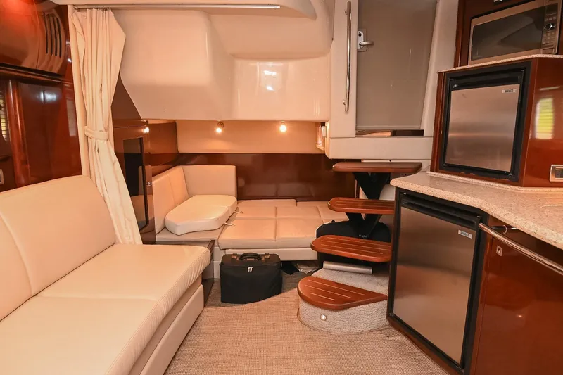 Slide: The Image of Interior of 2008 Sea Ray 38 Sundancer yacht with modern seating and kitchenette. - 36