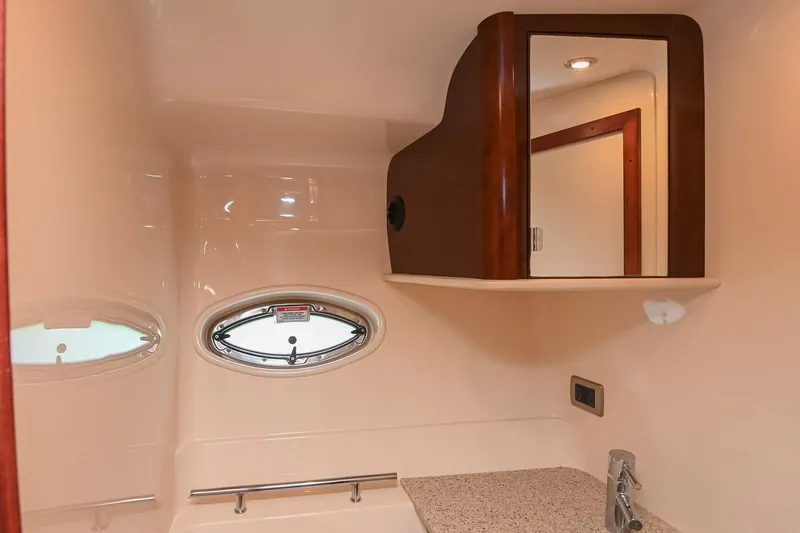 Slide: The Image of 2008 Sea Ray 38 Sundancer bathroom with oval window and mirrored cabinet. - 44