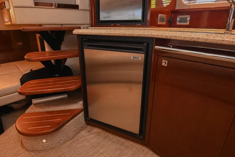 Slide: The Image of Interior of 2008 Sea Ray 38 Sundancer yacht with wooden steps and compact kitchen area. - 34