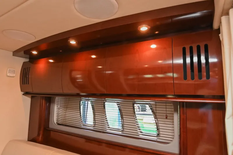 Slide: The Image of Interior of 2008 Sea Ray 38 Sundancer with wooden cabinets and window blinds. - 48