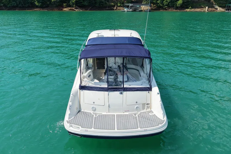 Slide: The Image of 2008 Sea Ray 38 Sundancer yacht on clear turquoise water, rear view. - 4