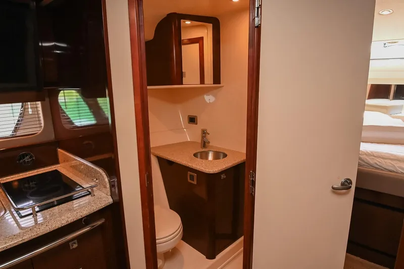 Slide: The Image of Interior of 2008 Sea Ray 38 Sundancer yacht featuring a compact bathroom and kitchenette. - 42