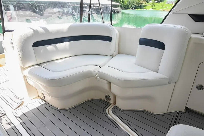 Slide: The Image of Luxurious seating area on a 2008 Sea Ray 38 Sundancer yacht, overlooking serene waters. - 13