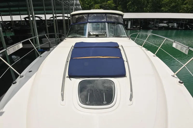 Slide: The Image of 2008 Sea Ray 38 Sundancer yacht docked, featuring a spacious deck and blue sun pads. - 29