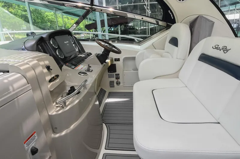 Slide: The Image of 2008 Sea Ray 38 Sundancer cockpit with luxurious seating and modern dashboard controls. - 17