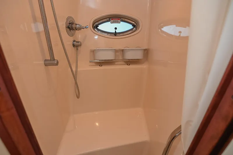 Slide: The Image of Shower area in 2008 Sea Ray 38 Sundancer yacht with porthole window. - 55