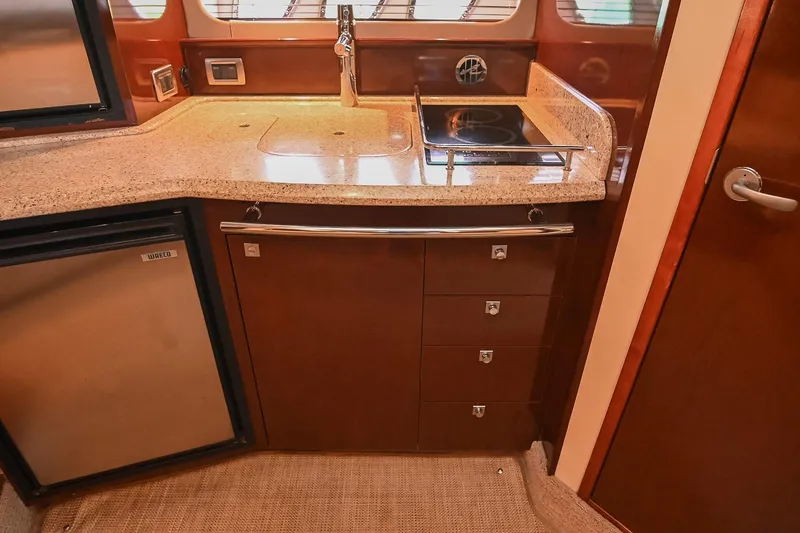Slide: The Image of Luxurious 2008 Sea Ray 38 Sundancer yacht kitchen with modern appliances and sleek cabinetry. - 41
