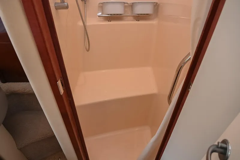 Slide: The Image of Shower area inside 2008 Sea Ray 38 Sundancer yacht, featuring a handheld showerhead and seating. - 56