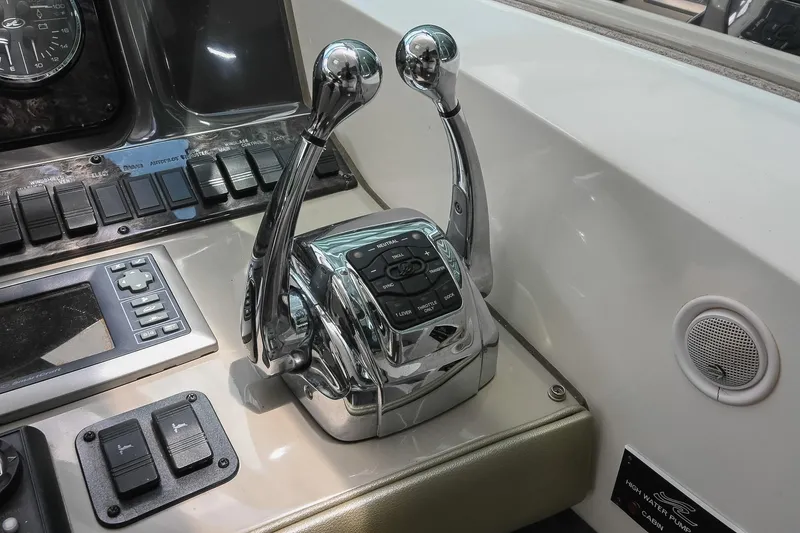 Slide: The Image of Control panel of a 2008 Sea Ray 38 Sundancer boat with chrome throttle levers. - 22