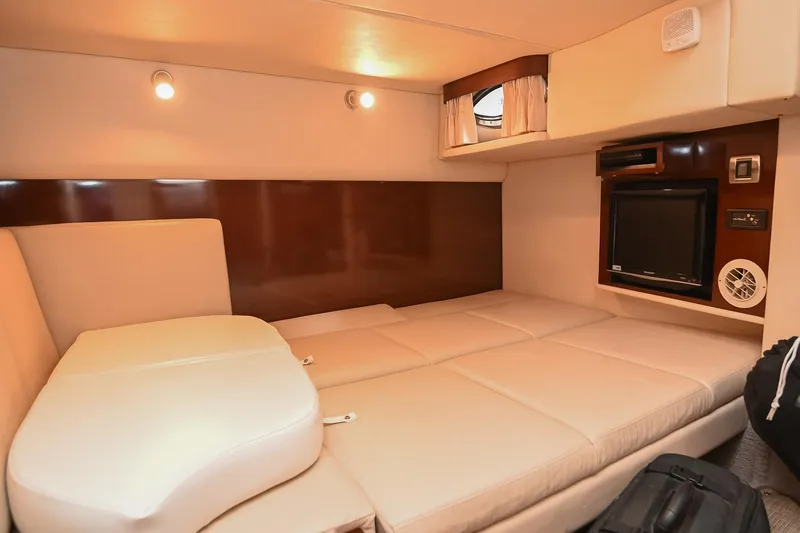 Slide: The Image of Interior cabin of 2008 Sea Ray 38 Sundancer with beige seating and entertainment system. - 40