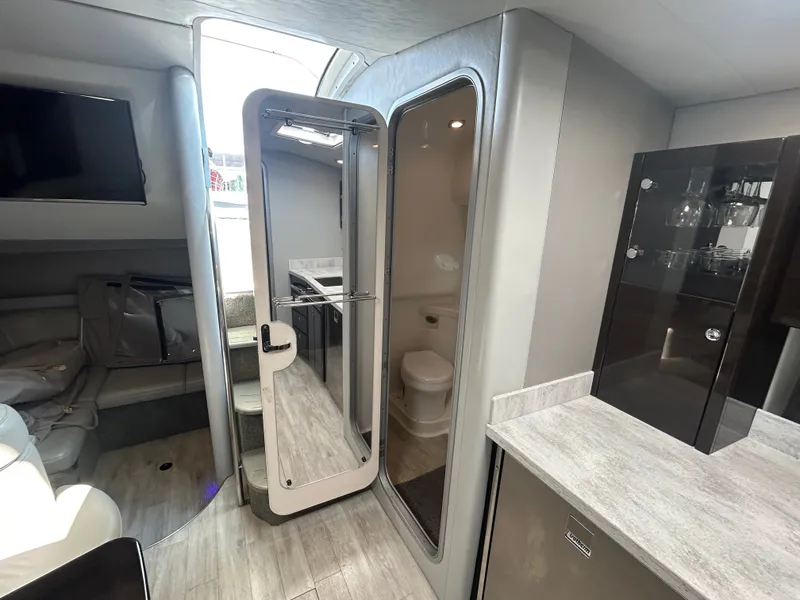 Slide: The Image of Interior of a modern yacht with sleek design, featuring a kitchen, bathroom, and seating area. - 37