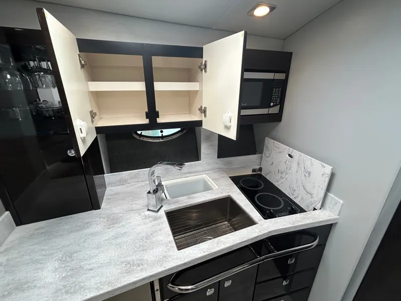 Slide: The Image of The galley of a 2017 Formula 37 Performance Cruiser with sink, stove, and microwave. - 44