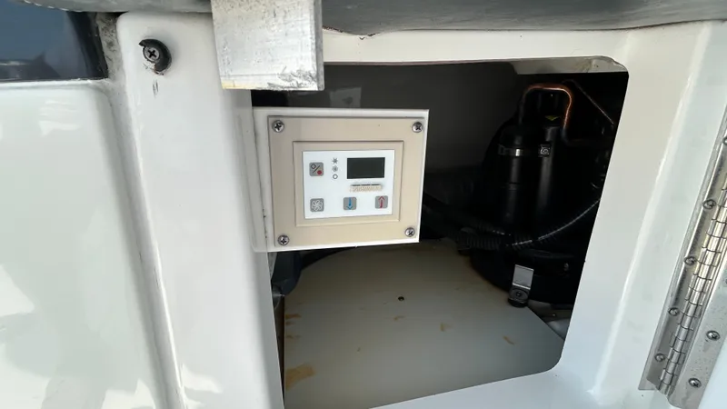 Slide: The Image of A control panel inside a boat, surrounded by technical components and wiring. - 17