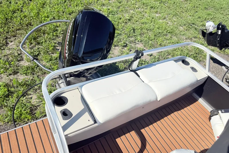 Slide: The Image of 2011 Sun Tracker Fishin' Barge 21 with Mercury outboard motor and cushioned seating. - 18